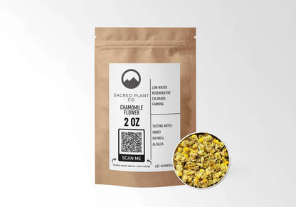 Sacred Plant Co Chamomile Flower 2 oz in a kraft stand-up pouch with a sample of whole dried chamomile flowers in a silver tin, naturally grown with low-water regenerative Colorado farming.