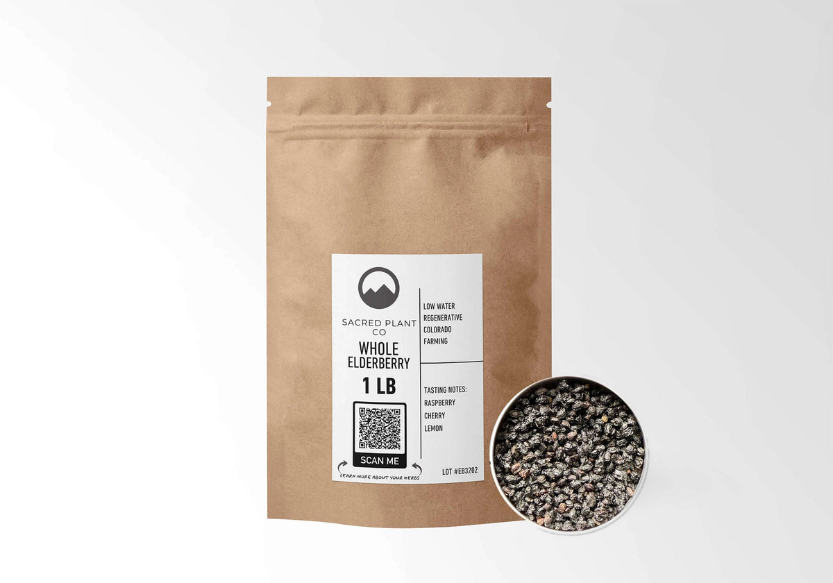 Sacred Plant Co Elderberries 1 LB kraft stand-up pouch shown with a sample of the berries.