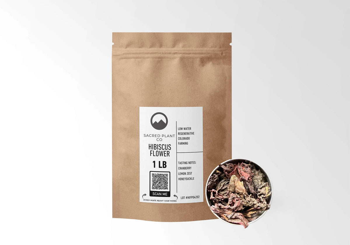 Sacred Plant Co Hibiscus Flowers 1 LB kraft stand-up pouch shown with a sample of the herb.