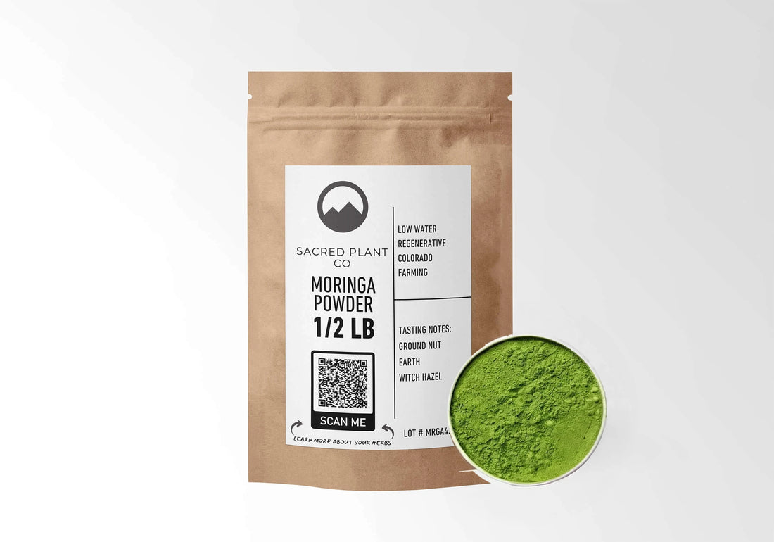 Sacred Plant Co Moringa Powder 1/2 LB kraft stand-up pouch shown with a sample of the powder.