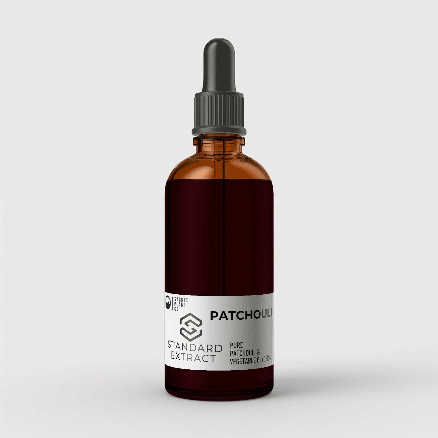 High-quality Sacred Plant Co Patchouli Standard Extract in amber glass bottle, perfect for enhancing natural skincare regimens, against a pristine white backdrop.
