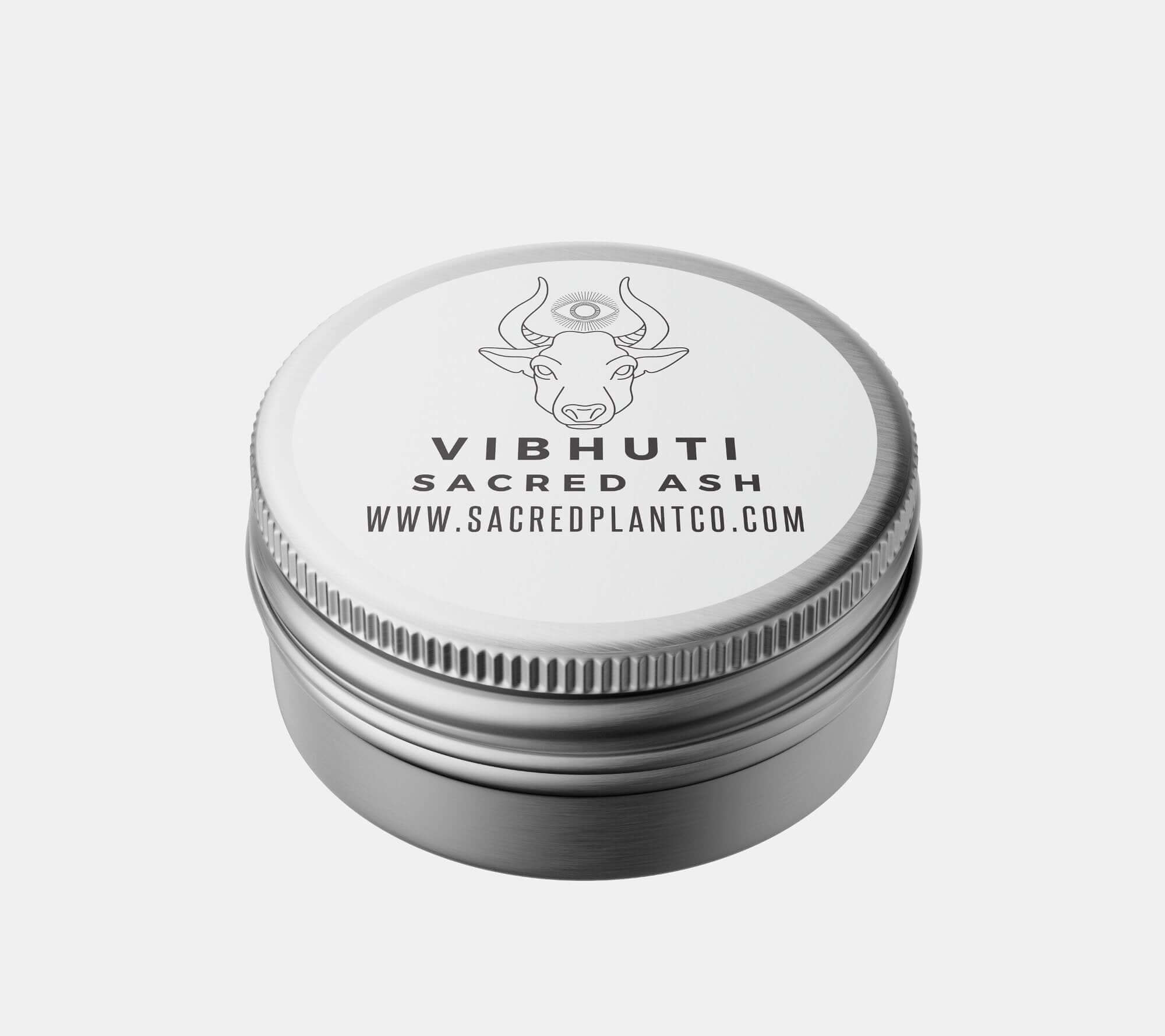 Vibhuti Sacred Ash in a silver tin, showcasing a cow and third eye design, from Sacred Plant Co, for spiritual and religious use, isolated on a white background.
