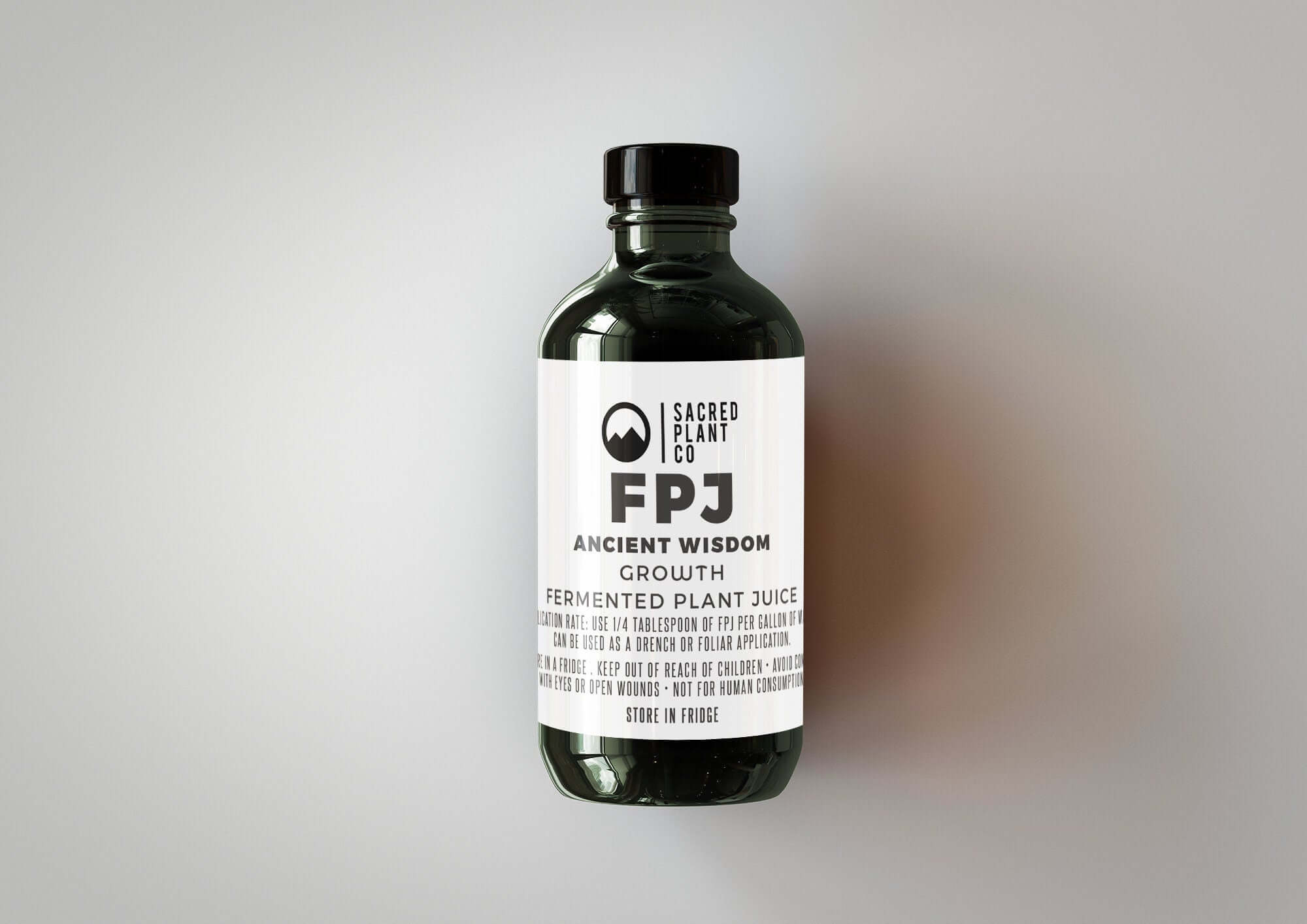 Closeup view of our Ancient Wisdom GROWTH - FPJ bottle, capturing the distinct branding of our Low Water Colorado Mountain Herb Farm products